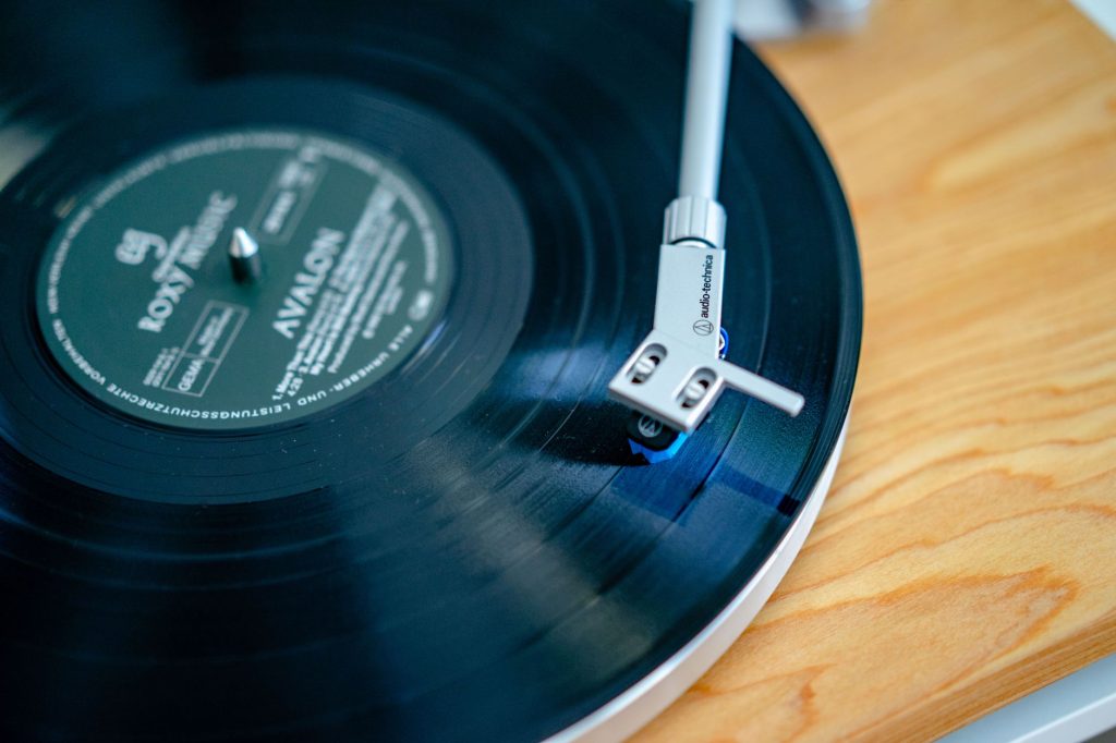 A close-up of a vintage turntable playing a vinyl record, capturing nostalgia.