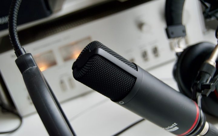 Close-up shot of a microphone in a studio setting, ideal for audio recording.