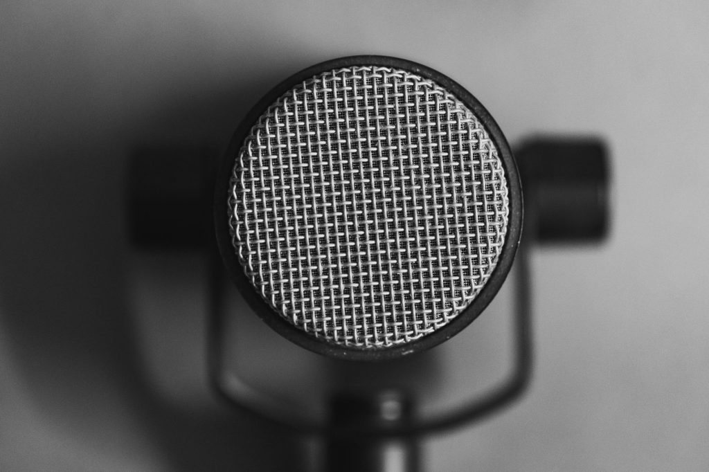 Black and white close-up of a professional studio microphone for sound recording.
