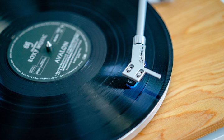 A close-up of a vintage turntable playing a vinyl record, capturing nostalgia.