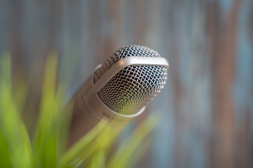 High-quality close-up of a dynamic microphone with a soft focus background, ideal for music or podcast themes.