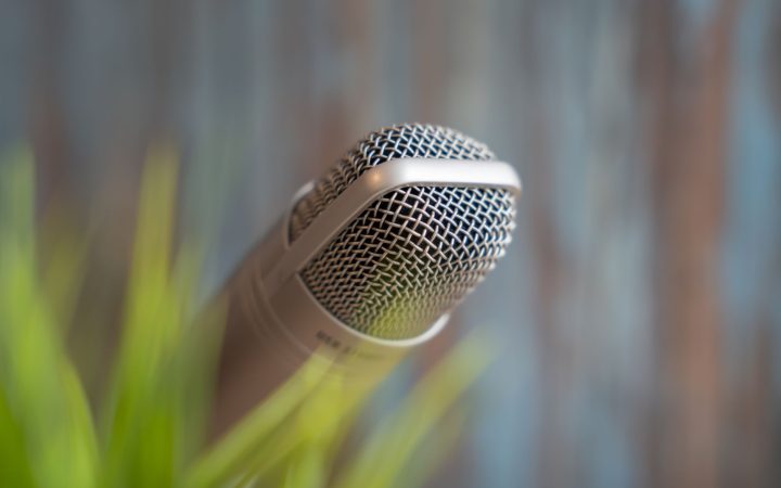 High-quality close-up of a dynamic microphone with a soft focus background, ideal for music or podcast themes.