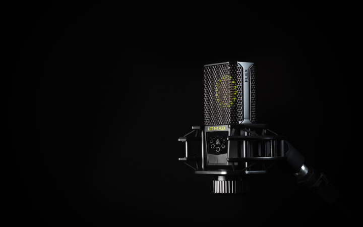 A detailed studio shot of a condenser microphone against a black background, emphasizing modern audio technology.