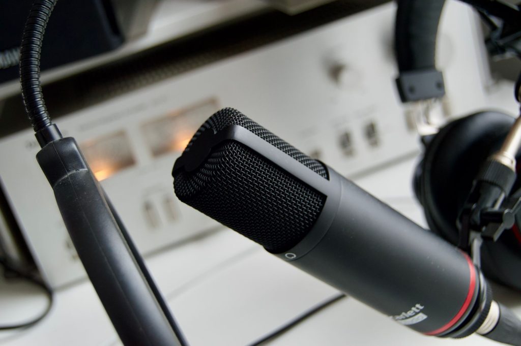 Close-up shot of a microphone in a studio setting, ideal for audio recording.