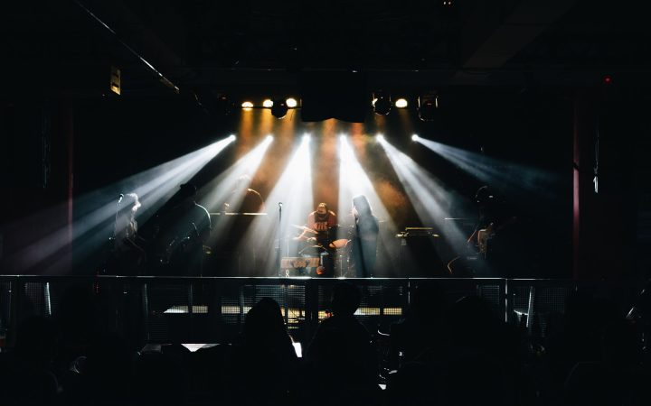 A vibrant live music concert in Lima, Peru, featuring musicians on stage with dramatic lighting.