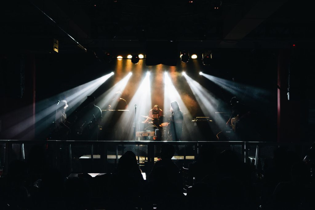 A vibrant live music concert in Lima, Peru, featuring musicians on stage with dramatic lighting.
