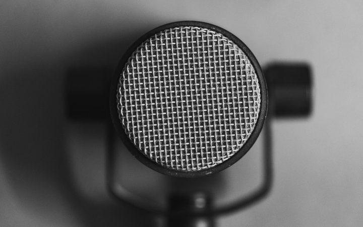 Black and white close-up of a professional studio microphone for sound recording.