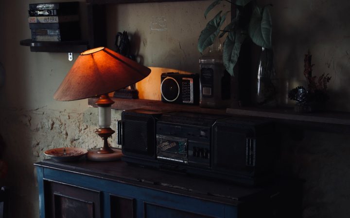 Cozy vintage interior with a warm lamp illuminating a wooden cabinet and retro radio.