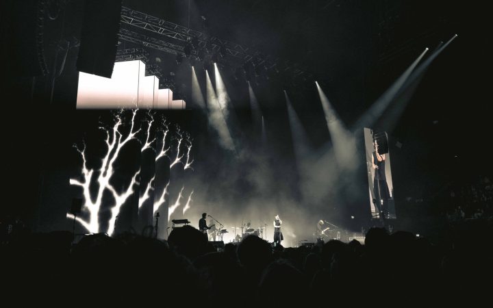 Engaging night concert with lights, smoke, and audience in Amsterdam.