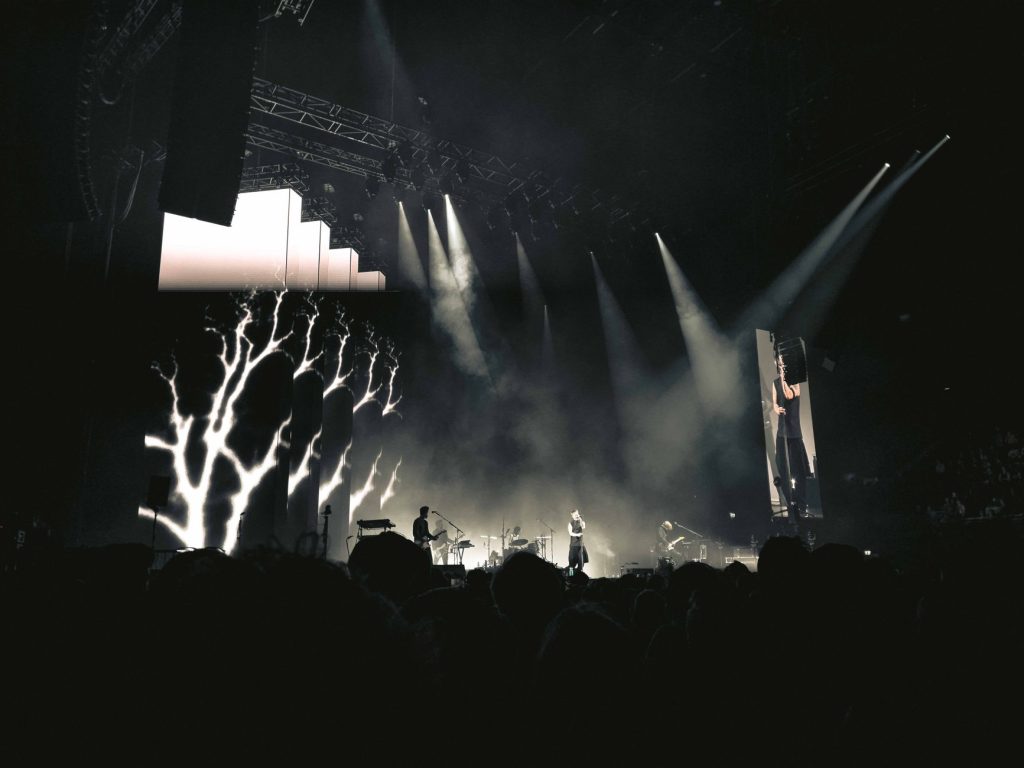 Engaging night concert with lights, smoke, and audience in Amsterdam.